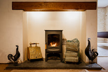 Load image into Gallery viewer, A wood burning stove with a net of logs.